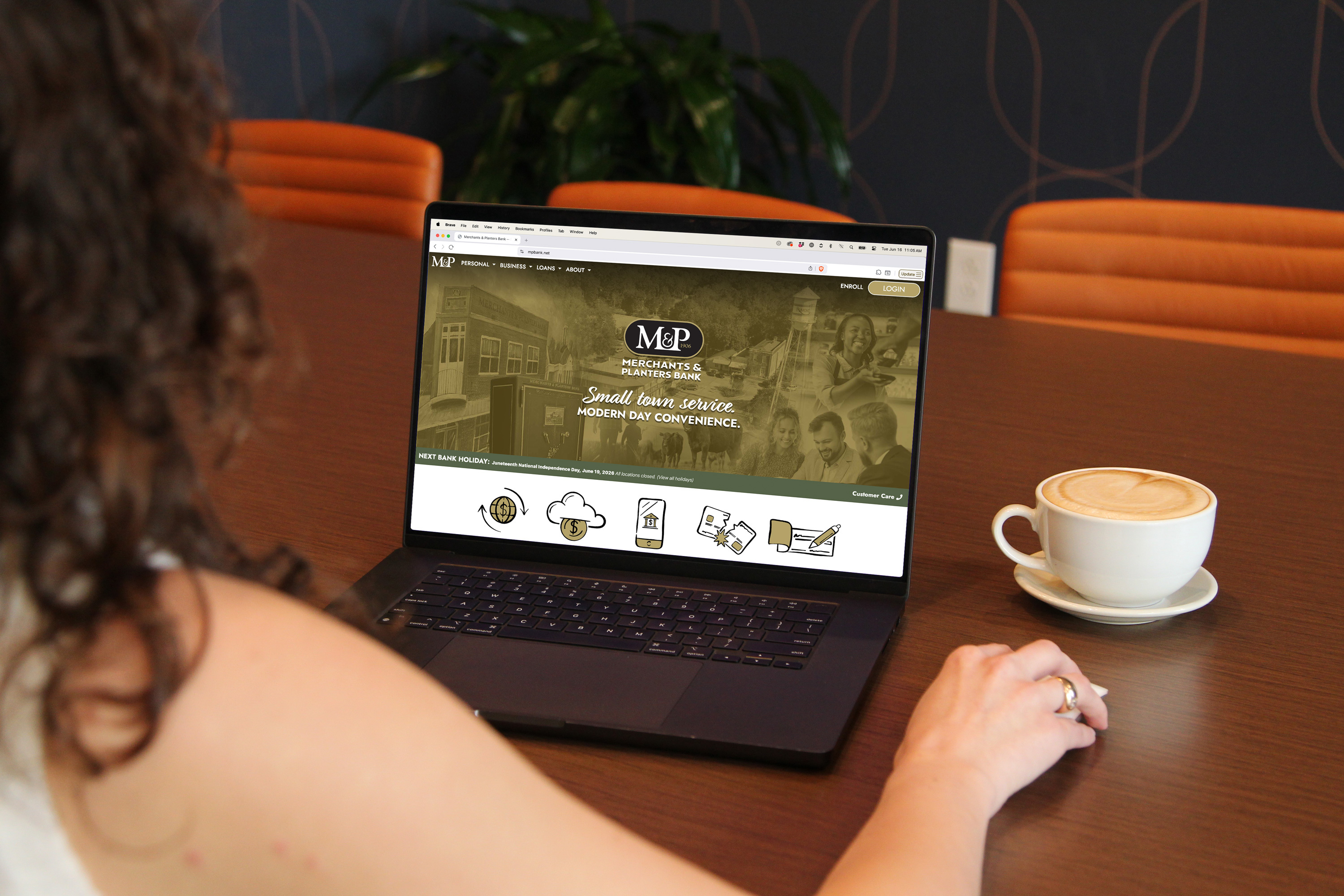 The Merchants & Planters Bank homepage on a laptop in a warm, everyday setting